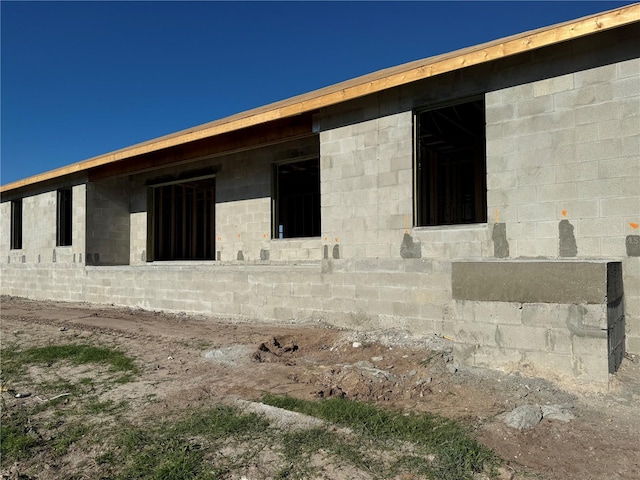 view of side of property featuring concrete block siding