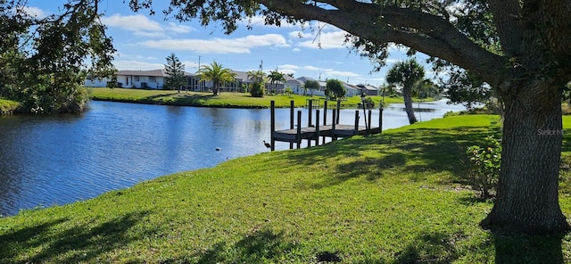 view of dock with a water view, a residential view, and a lawn