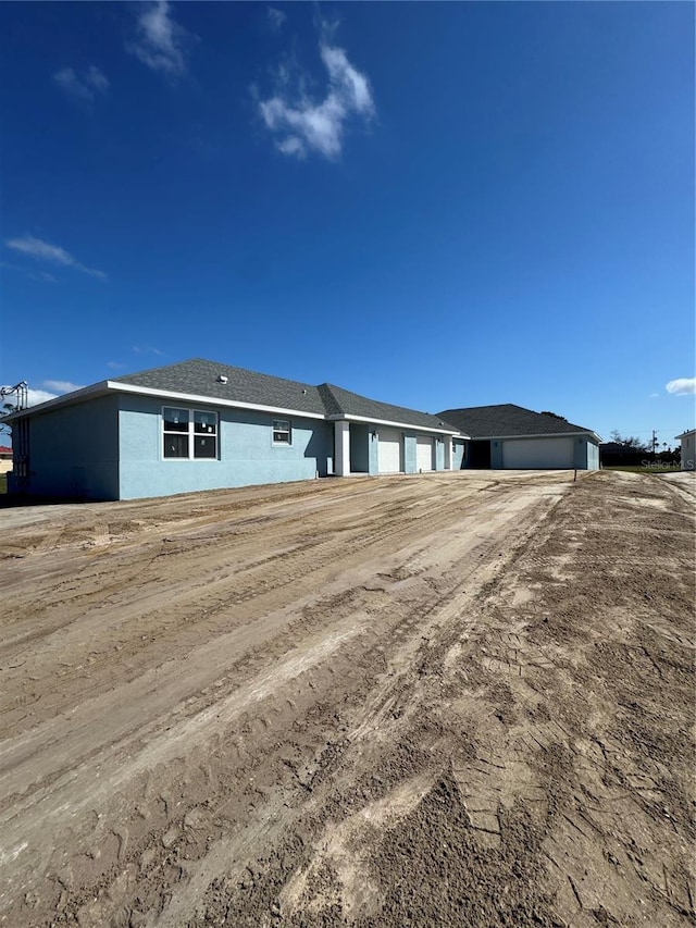 ranch-style home with stucco siding