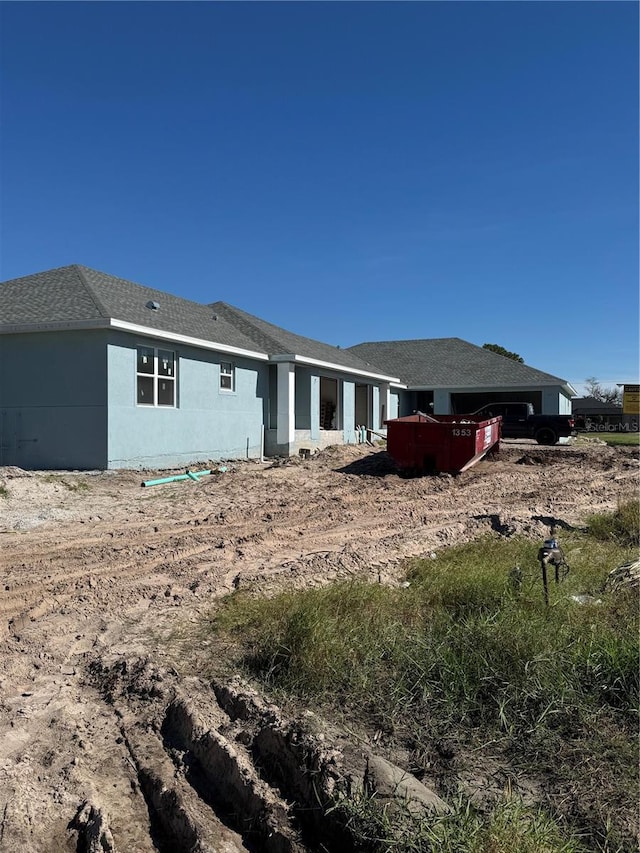 rear view of house with stucco siding