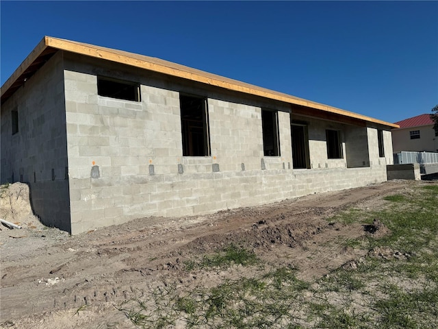 view of side of property with concrete block siding