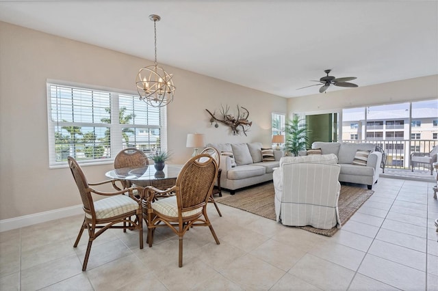 tiled dining area with ceiling fan with notable chandelier