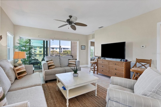 living room featuring ceiling fan and light tile flooring