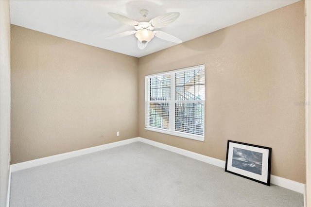 carpeted empty room featuring ceiling fan