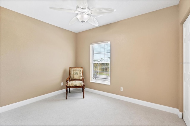 living area with ceiling fan and light colored carpet