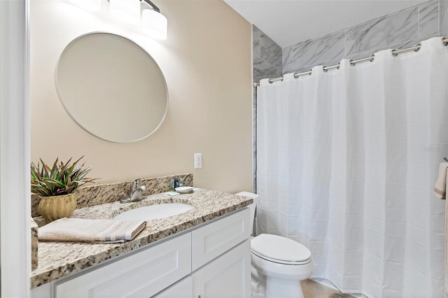 bathroom featuring toilet, tile flooring, and oversized vanity