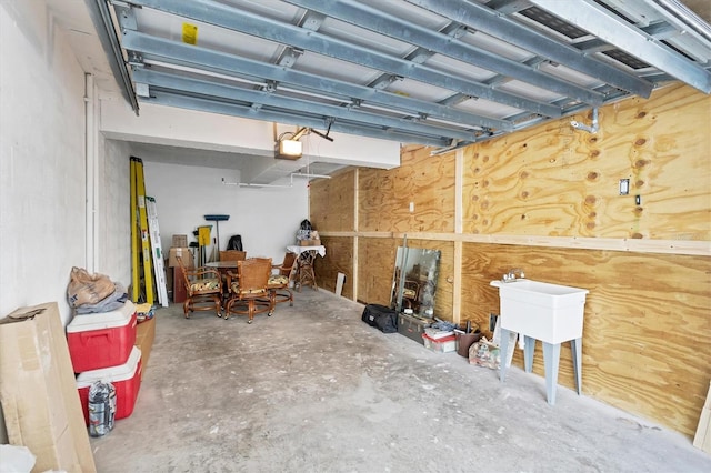 garage with a garage door opener and sink