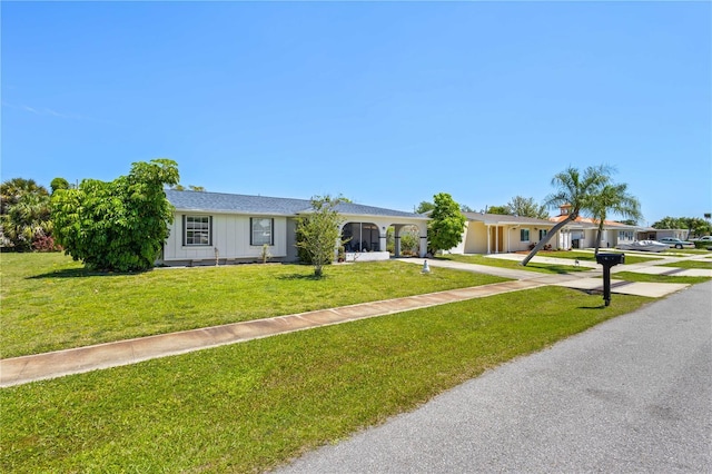 ranch-style home featuring a front yard