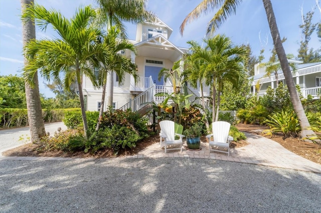 beach home featuring a patio and a balcony