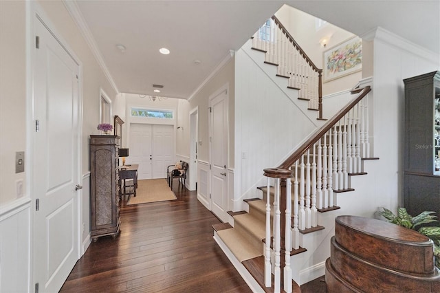 entrance foyer featuring crown molding and dark hardwood / wood-style floors