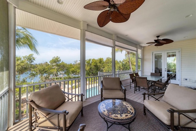 sunroom / solarium with french doors and ceiling fan