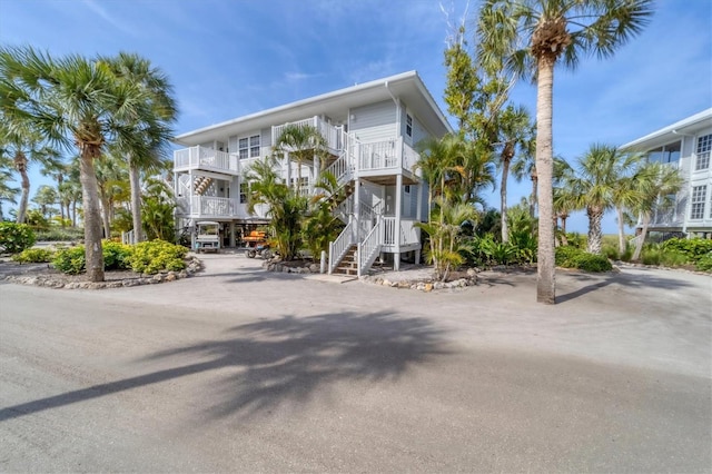 raised beach house featuring a balcony