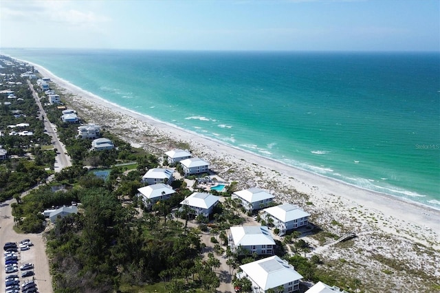 drone / aerial view featuring a beach view and a water view