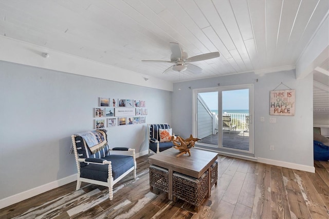 living area featuring ceiling fan, crown molding, a water view, and dark wood-type flooring