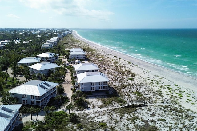 birds eye view of property featuring a water view and a view of the beach