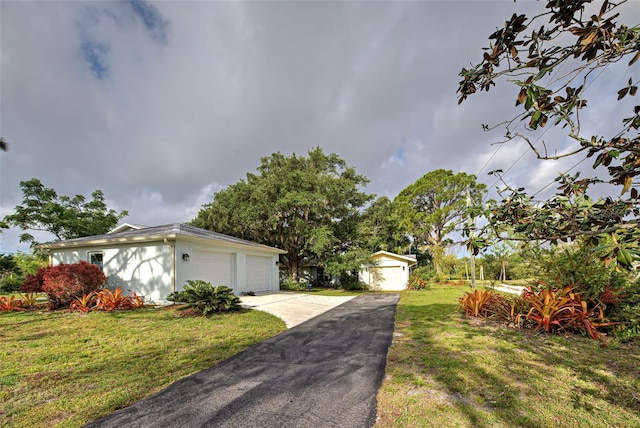 exterior space with a yard and a garage