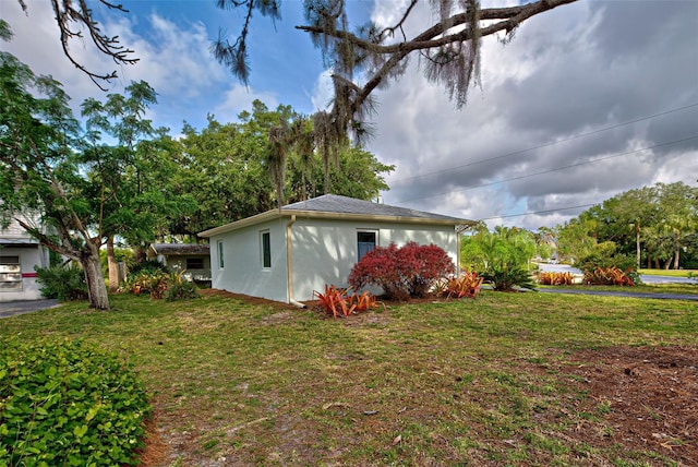 view of side of property with a lawn