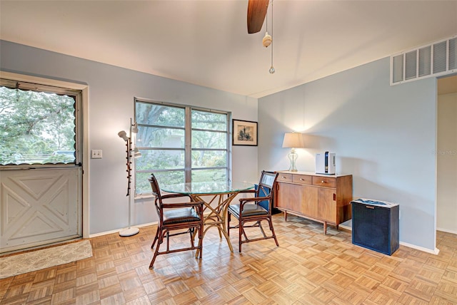 dining space with ceiling fan and light parquet floors