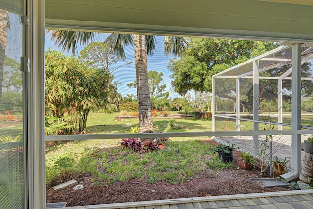 view of yard with glass enclosure