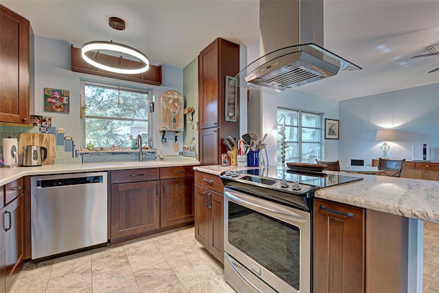 kitchen featuring island exhaust hood, light stone countertops, ceiling fan, and appliances with stainless steel finishes