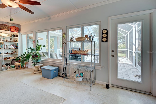 sunroom / solarium featuring ceiling fan