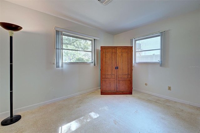 unfurnished bedroom featuring multiple windows