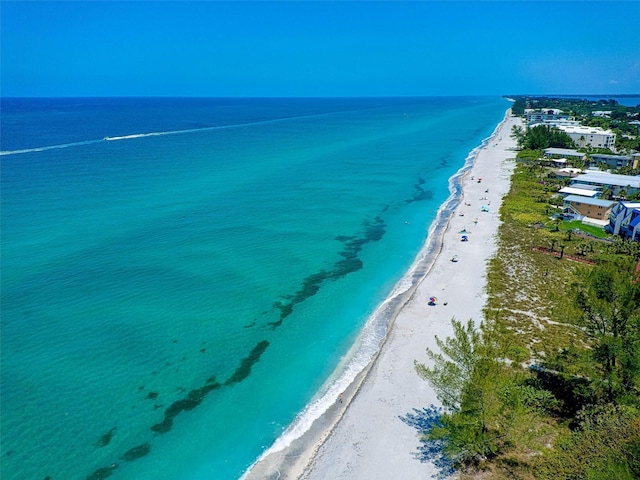 birds eye view of property featuring a beach view and a water view