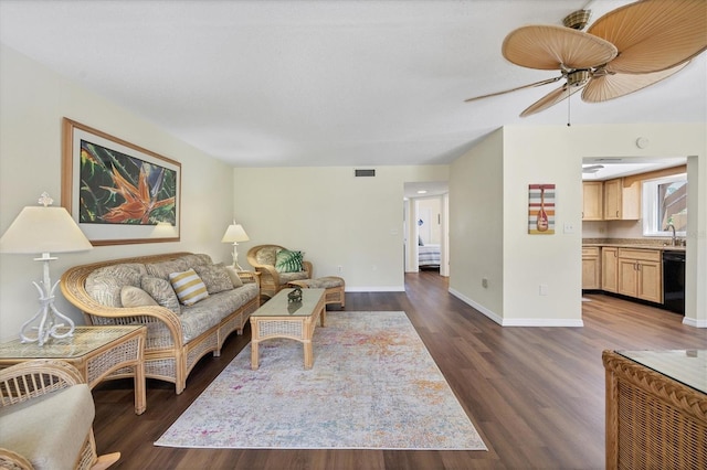 living room with ceiling fan and dark wood-type flooring