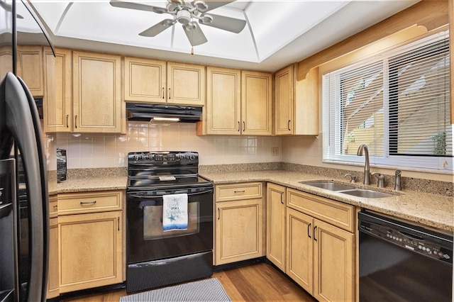 kitchen featuring black appliances, range hood, sink, ceiling fan, and hardwood / wood-style flooring