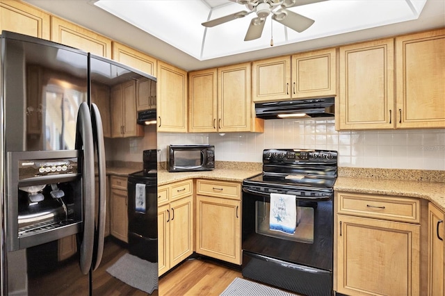 kitchen with light hardwood / wood-style floors, stainless steel fridge with ice dispenser, fume extractor, ceiling fan, and black range with electric stovetop