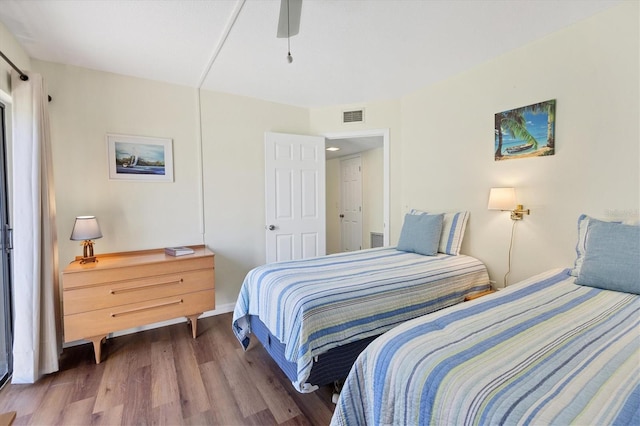 bedroom with ceiling fan and dark wood-type flooring