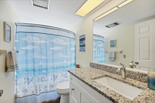 bathroom featuring toilet and vanity with extensive cabinet space