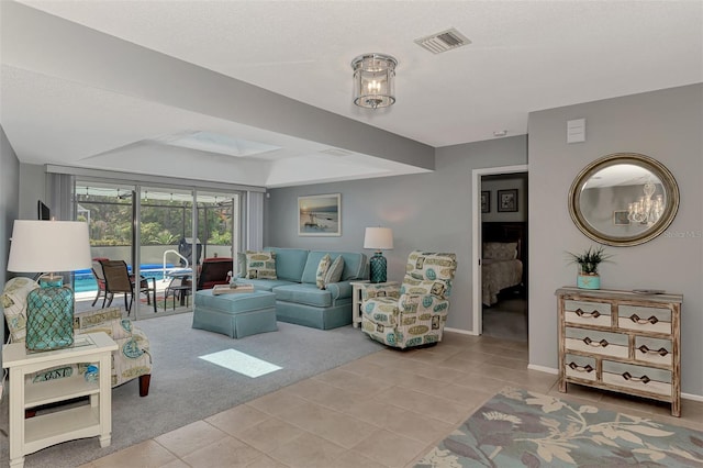 carpeted living room with a tray ceiling