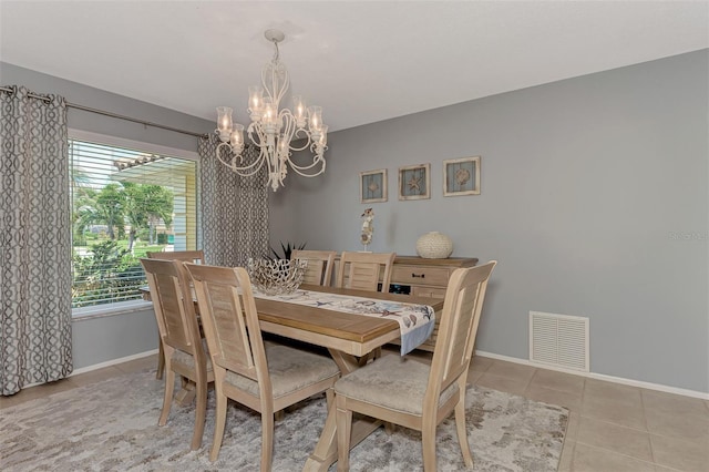 tiled dining space featuring a chandelier