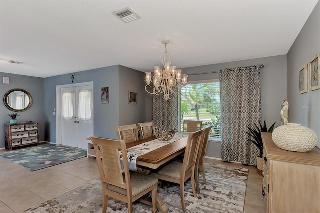 dining room featuring a notable chandelier and light tile floors