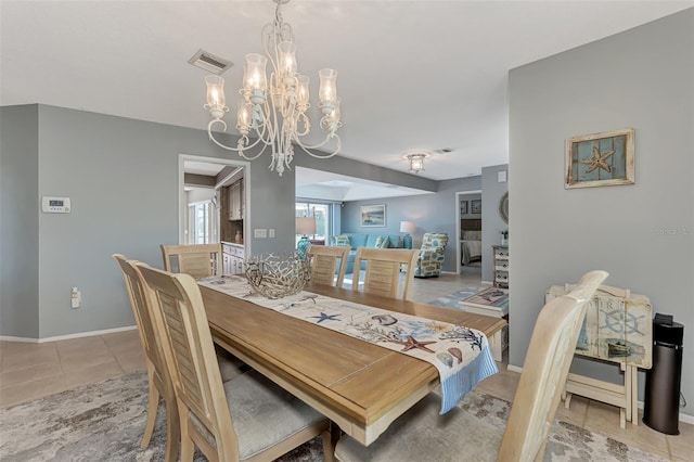 tiled dining space featuring a notable chandelier