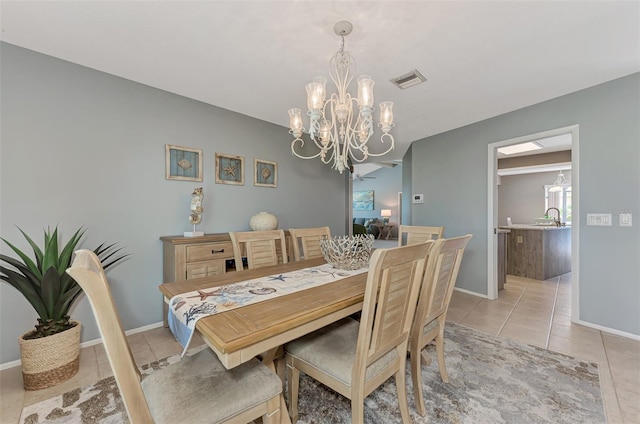 tiled dining space with a notable chandelier and sink