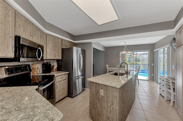 kitchen featuring appliances with stainless steel finishes, tasteful backsplash, sink, light stone countertops, and hanging light fixtures