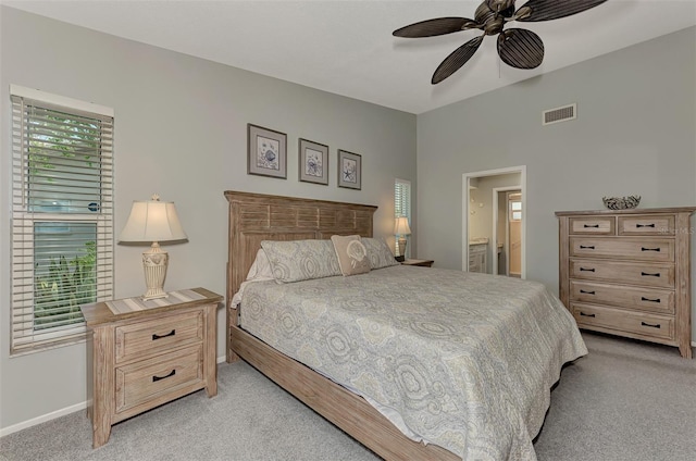 carpeted bedroom featuring connected bathroom and ceiling fan