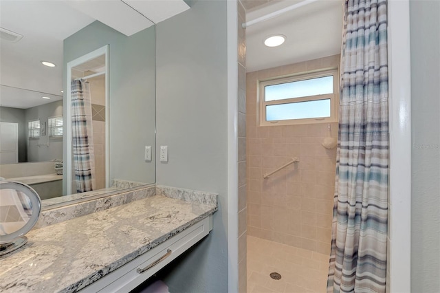 bathroom featuring curtained shower and vanity