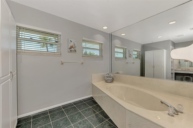 bathroom featuring a tub and tile flooring