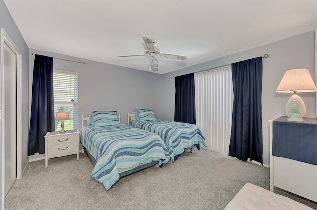 bedroom with ceiling fan and light carpet