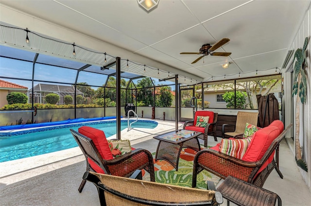 view of pool featuring a lanai, ceiling fan, an outdoor living space, and a patio