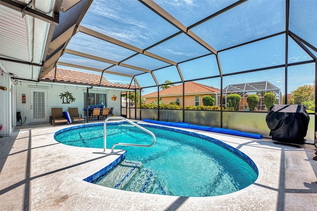 view of pool with a lanai and a patio area