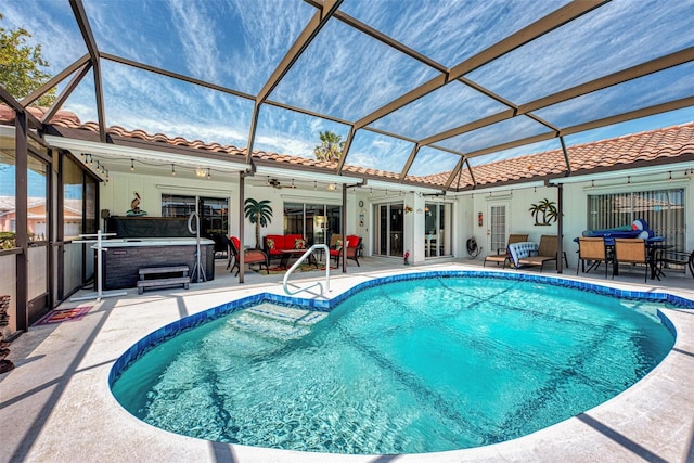 view of swimming pool featuring a patio area, ceiling fan, a hot tub, and a lanai