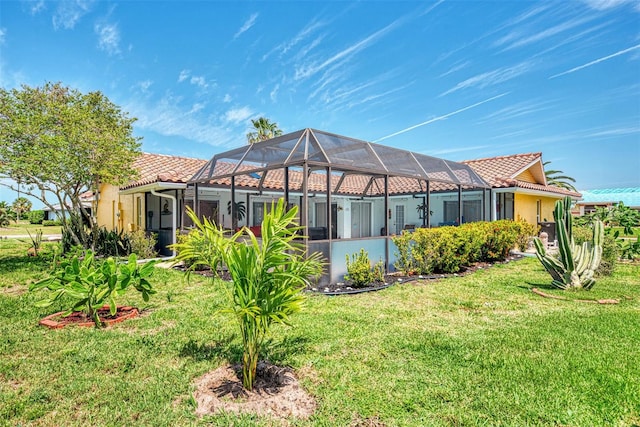 back of property with a lawn and glass enclosure