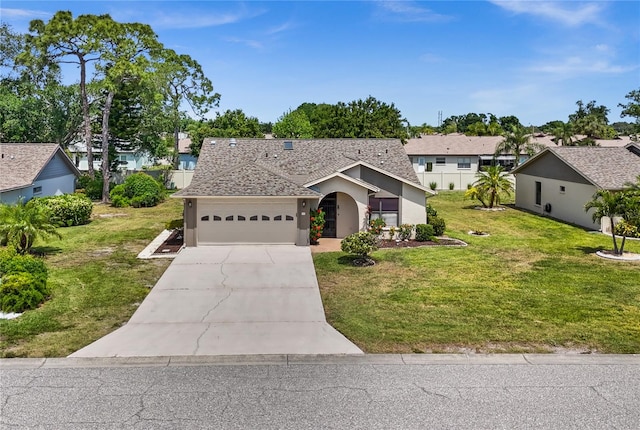 view of front of house featuring a front lawn and a garage