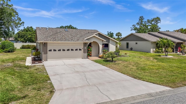 ranch-style home featuring a front lawn and a garage