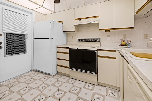 kitchen with white cabinetry, light tile flooring, tasteful backsplash, and white appliances