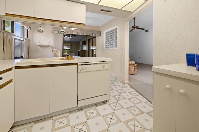 kitchen with ceiling fan, white dishwasher, light tile flooring, and white cabinets